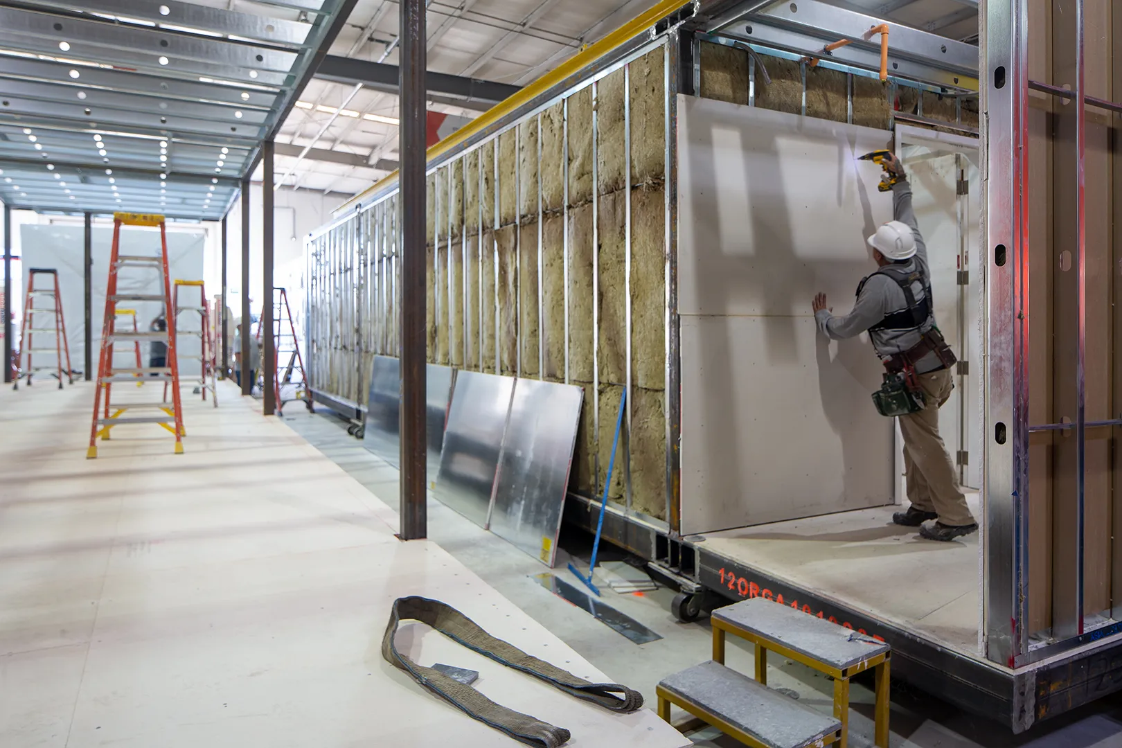 Module interior with wall systems being installed